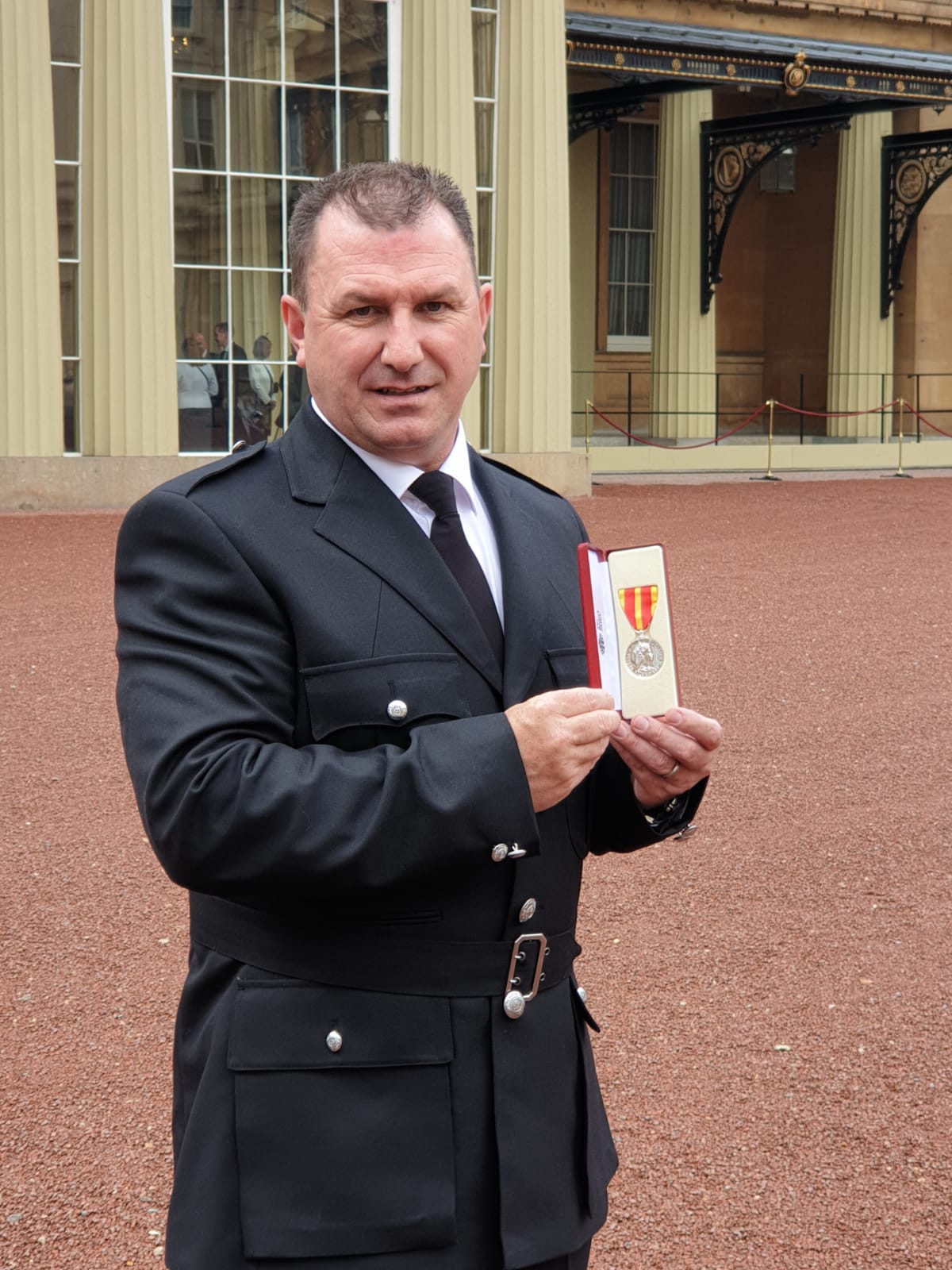 Tommy Richardson with his medal at Buckingham Palace